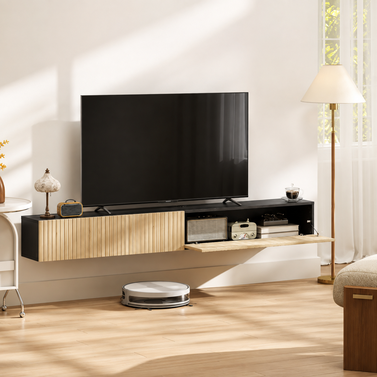 Meuble TV suspendu bois clair et noir avec rangement ouvert, installé sous une télévision dans un salon lumineux.